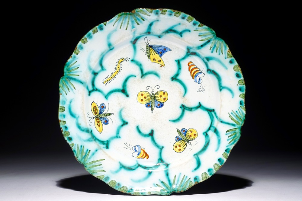 A Brussels faience plate with butterflies and caterpillars, 18/19th C.