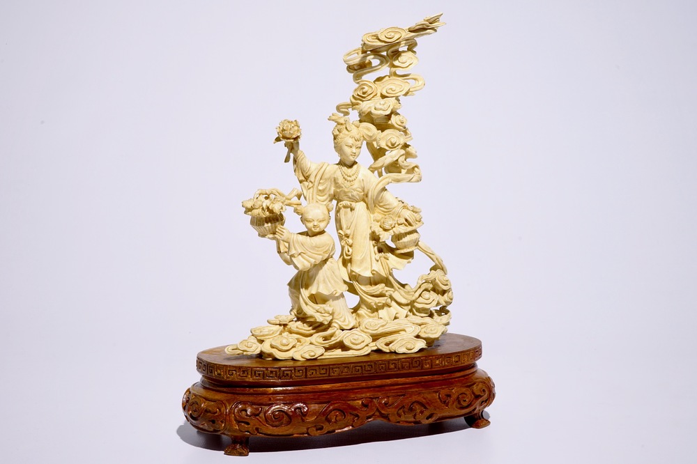 A Chinese carved ivory group of Lan Cai He with a servant, early 20th C.