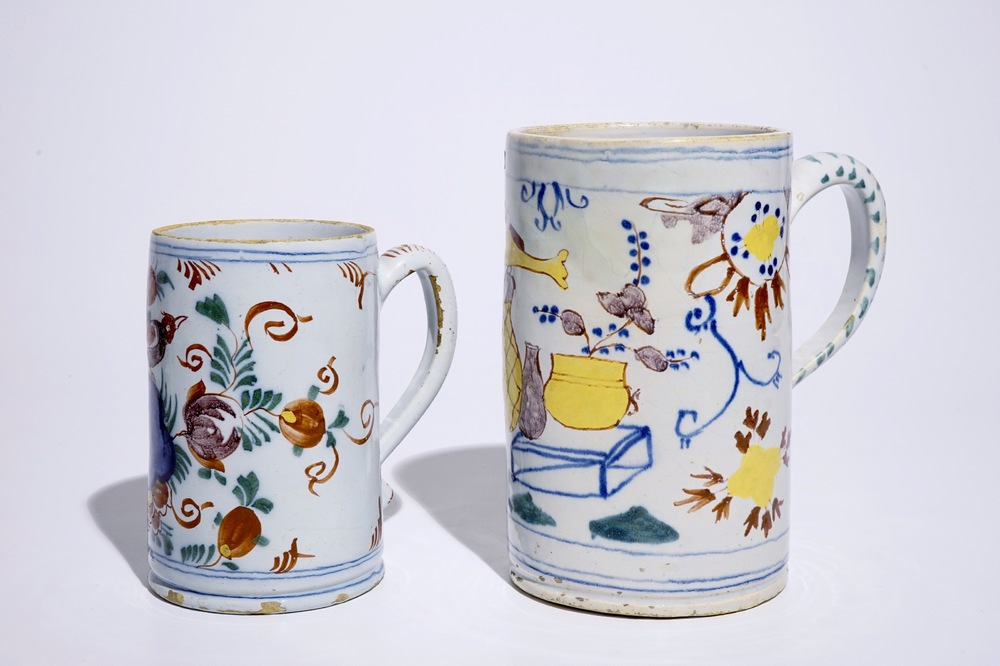 Two polychrome Dutch Delft mugs with birds, vases and flowers, 18th C.