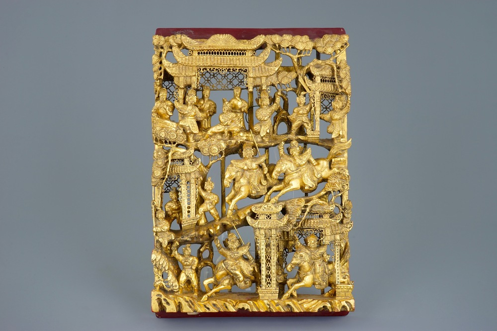 A Chinese carved gilt wood panel with a fighting scene, Ningbo, 19/20th C.
