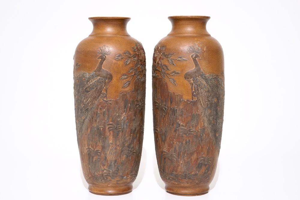 A pair of Chinese Yixing stoneware vases with applied peacock design, 20th C.