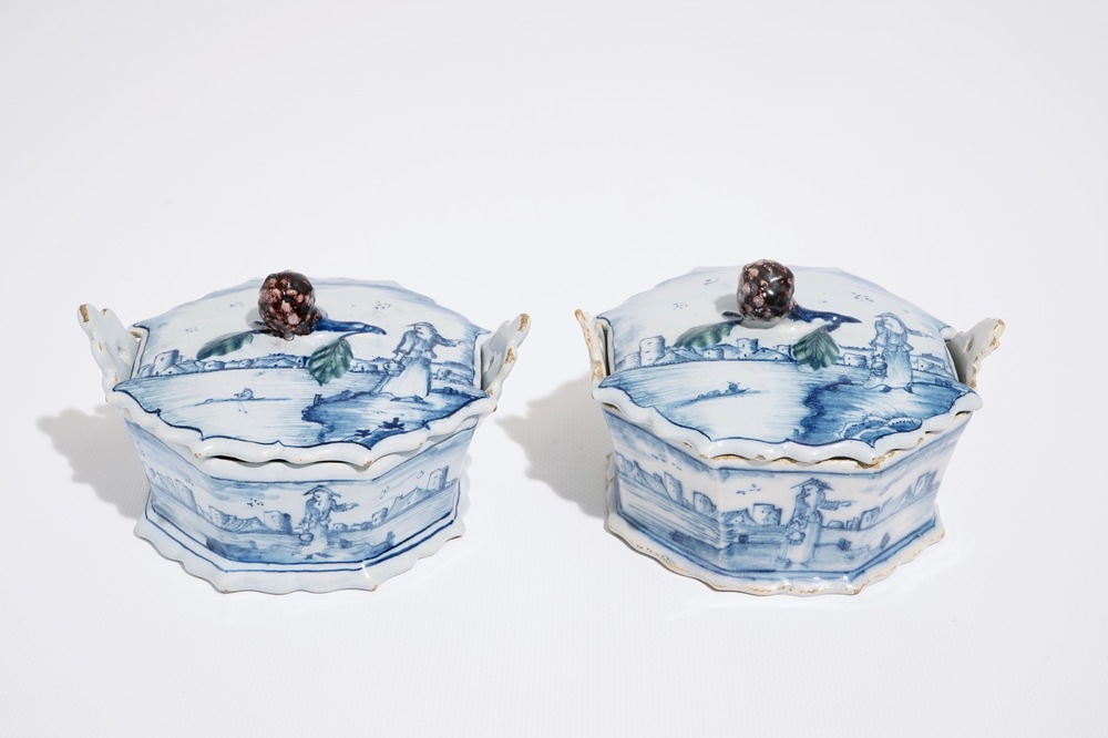 A pair of Dutch Delft blue and white butter tubs with blackberry finials, 18th C.