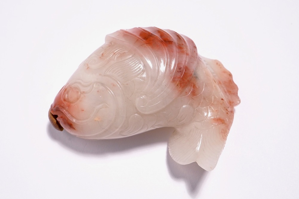 A Chinese carved red and white jade snuff bottle in the shape of a carp, 19th C.