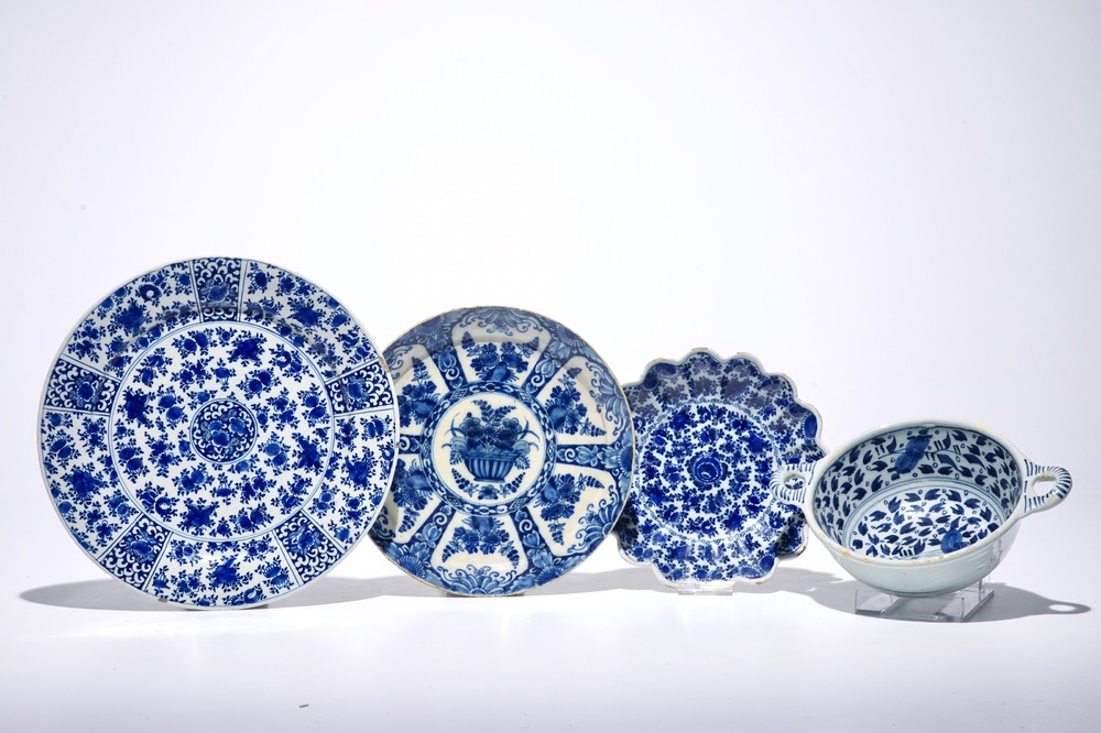 Three Dutch Delft blue and white plates and a two-eared porringer, 17/18th C.