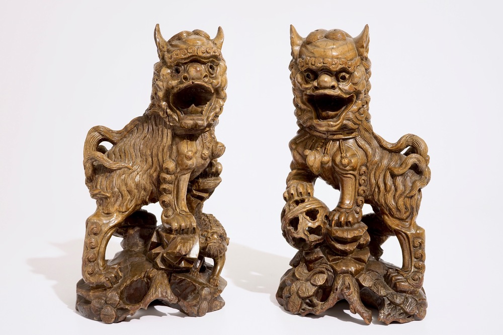 A pair of Chinese carved wood figures of temple lions, 19/20th C.