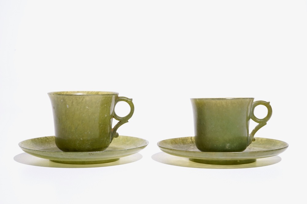 A pair of Chinese green jade cups and saucers, 19th C.