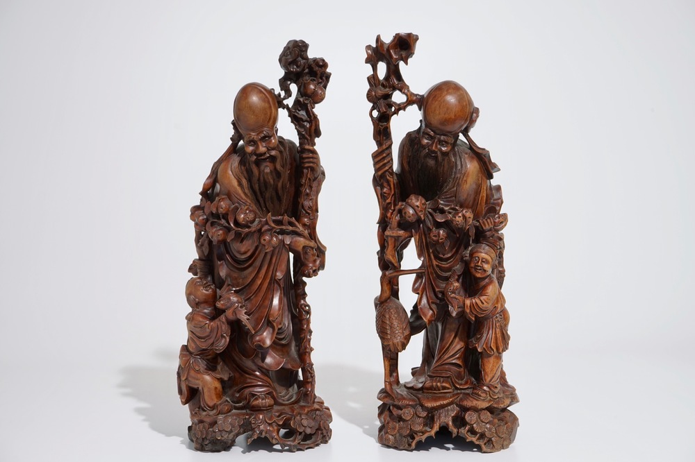 A pair of tall Chinese carved wood figures of immortals, 19/20th C.