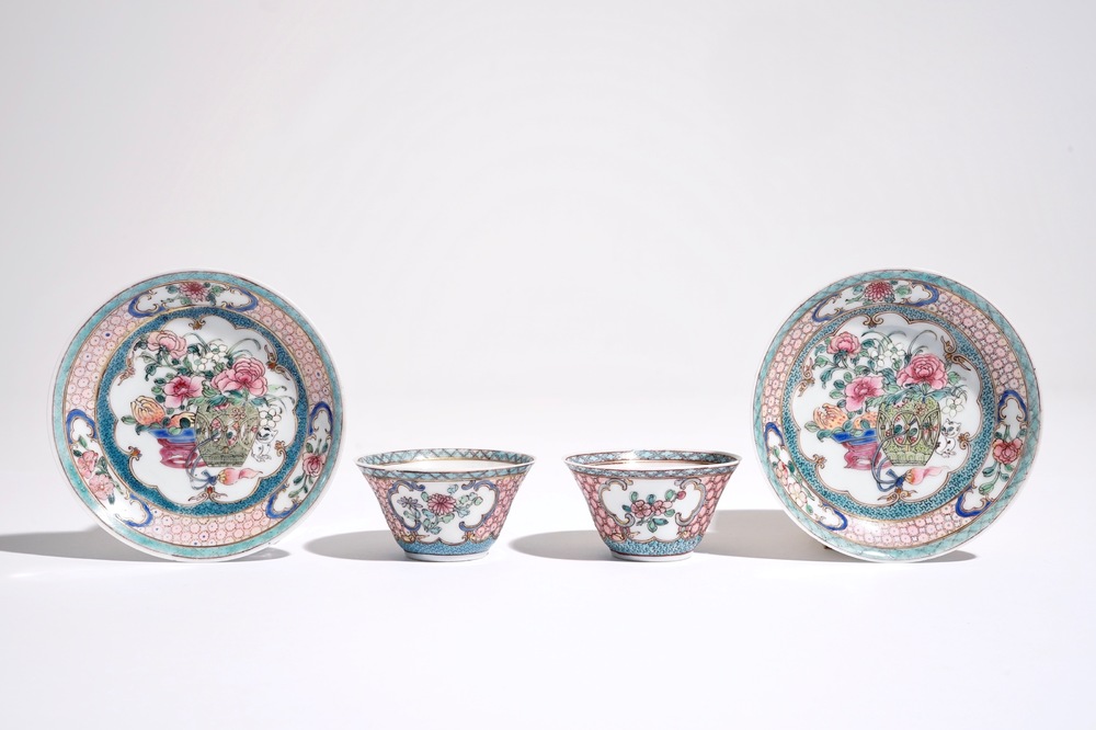 A pair of Chinese famille rose cups and saucers with a cat near a flower basket, Yongzheng