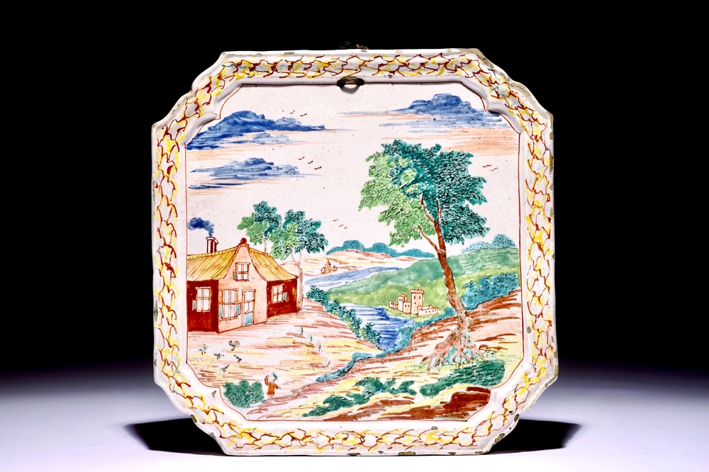 A square Dutch Delft polychrome petit feu plaque with a landscape, 18th C.
