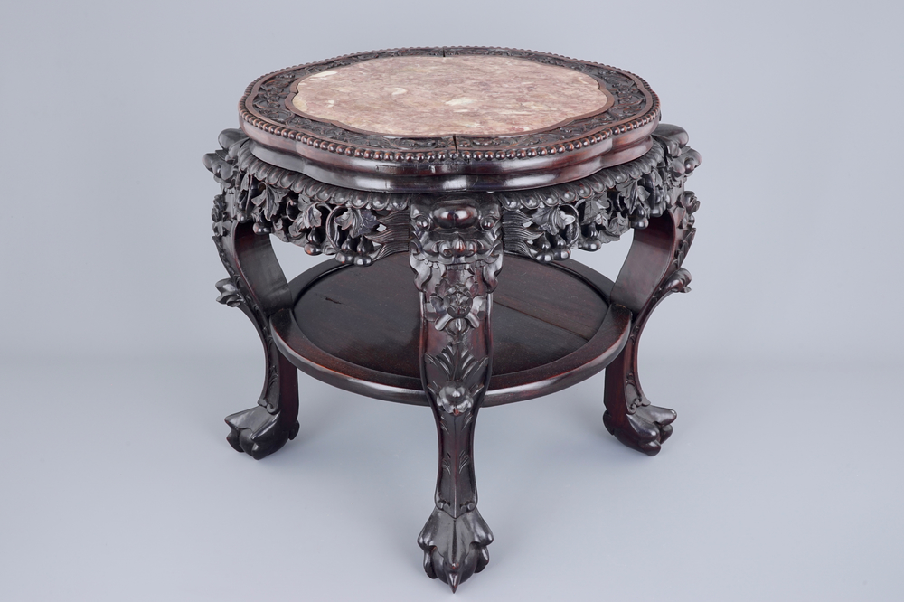 A large round Chinese carved wood stand with marble inset, 19th C.