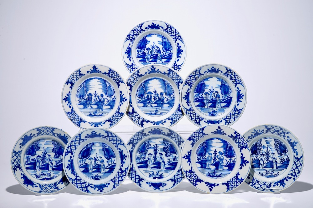 A set of nine Dutch Delft blue and white plates with a couple in a landscape, 18th C.
