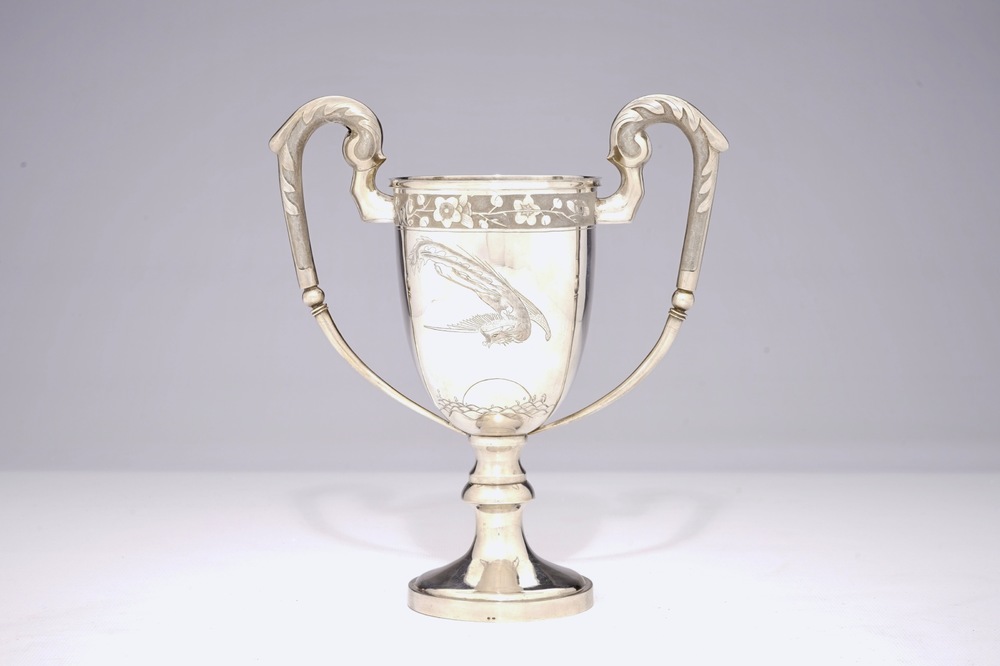 A Chinese silver two-handled trophy cup with a phoenix, 19th C.