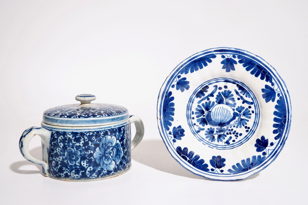 A Dutch Delft blue and white butter tub and cover and a small fluted plate, 18th C.