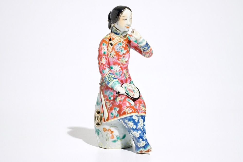 A Chinese famille rose model of a lady on a garden seat, 19th C.