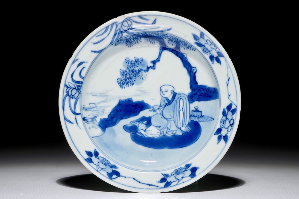 A small Chinese blue and white plate with a monk near the water, Transitional period