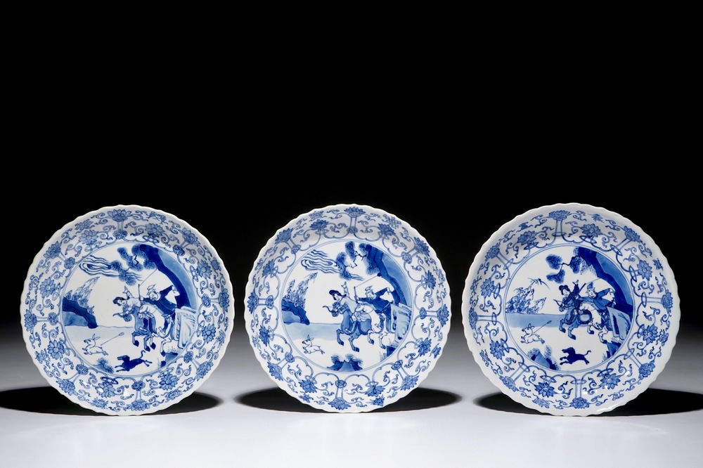 Three Chinese blue and white fluted plates with a Mongolian hunting scene, Chenghua marks, Kangxi