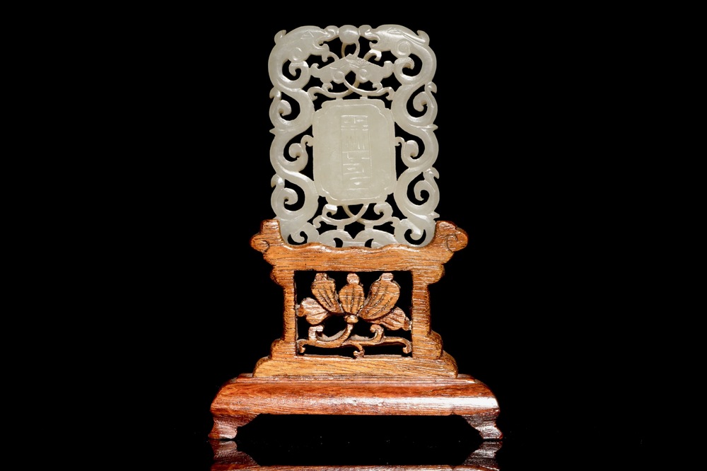 A Chinese white jade plaque with dragons and Taoist symbols, 19th C.