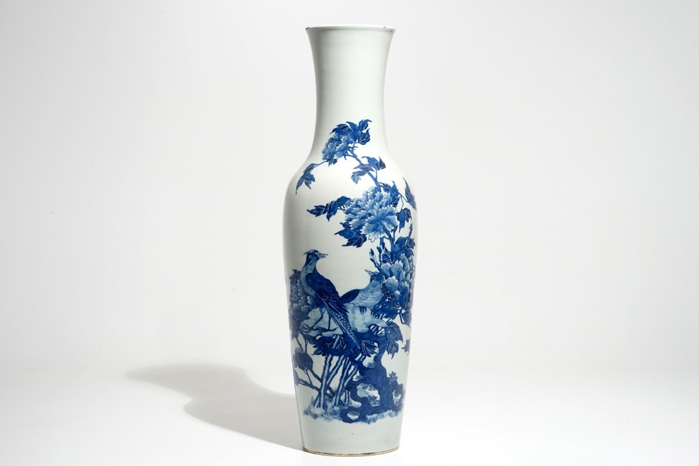 A tall Chinese blue and white vase with pheasants among flower blossoms, 19th C.