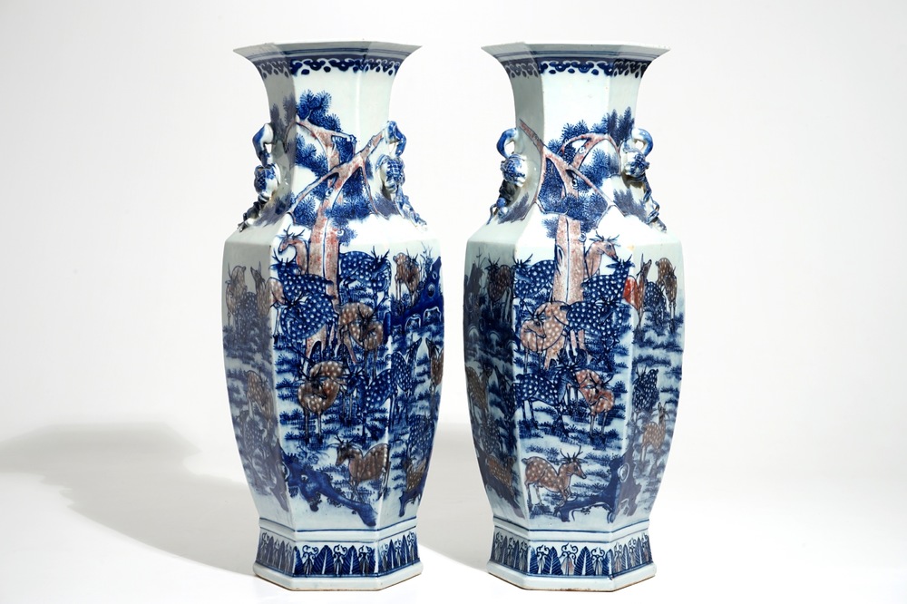 A pair of Chinese blue and underglaze red vases with deer and Buddhist lions, 19th C.