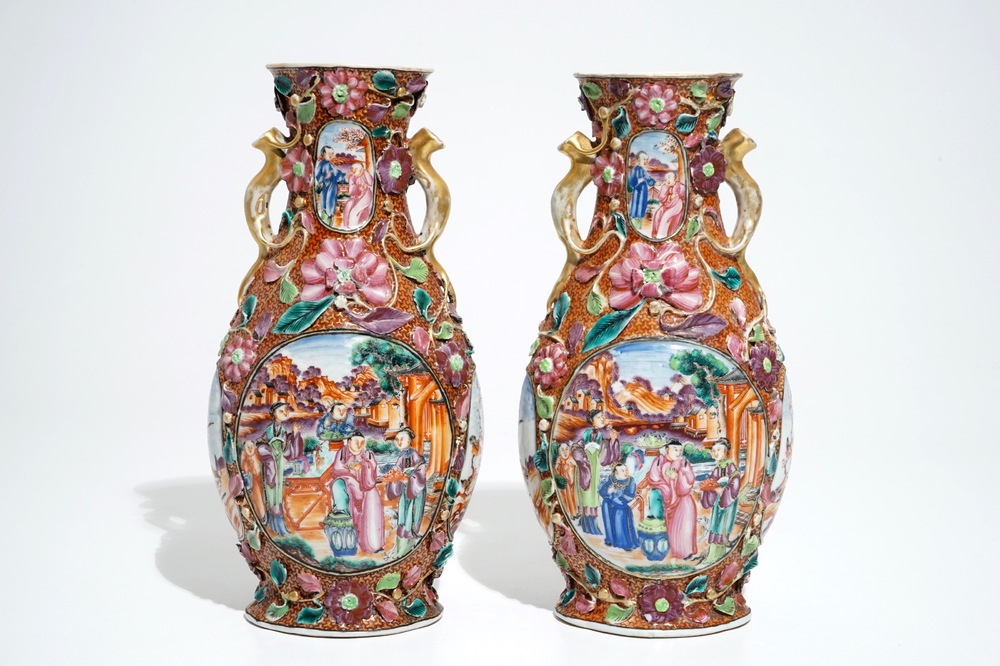 A pair of Chinese famille rose relief-decorated mandarin vases, Qianlong
