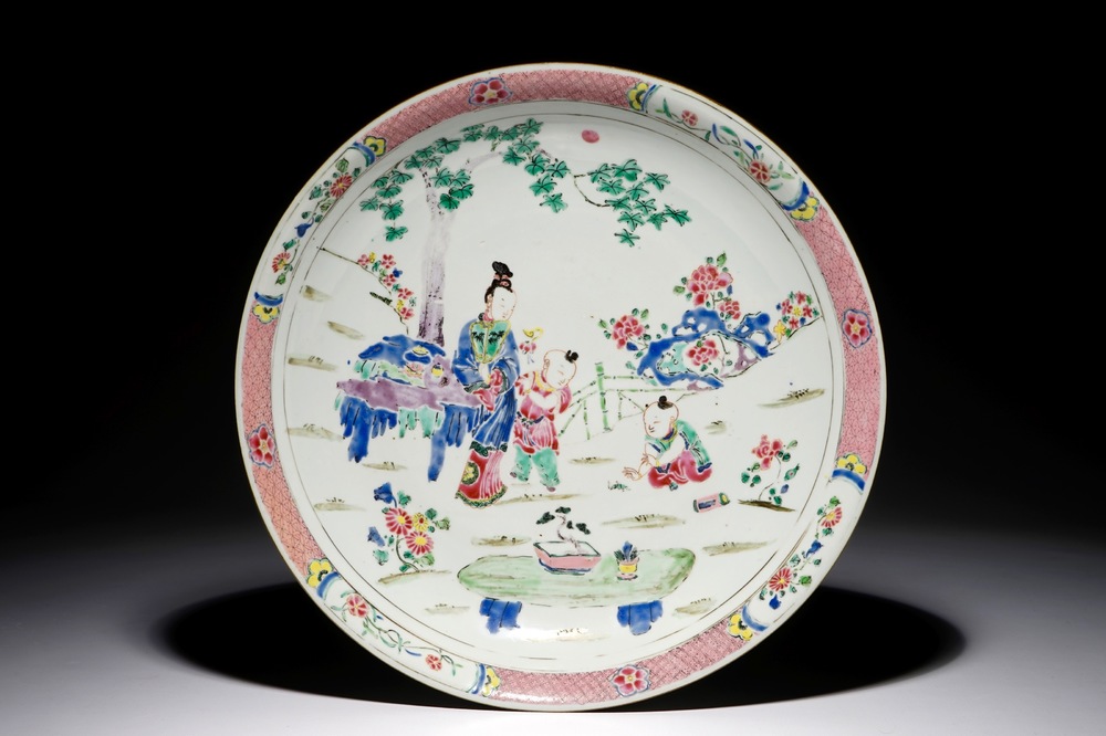 A Chinese famille rose dish with figures in a garden, Yongzheng