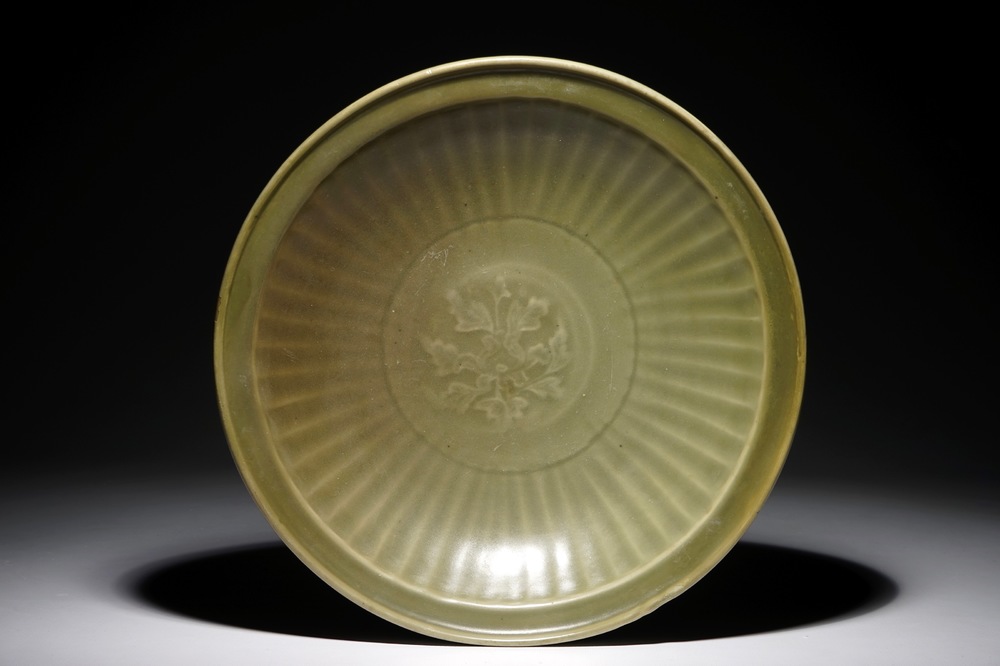A Chinese Longquan celadon dish with floral underglaze design, Ming