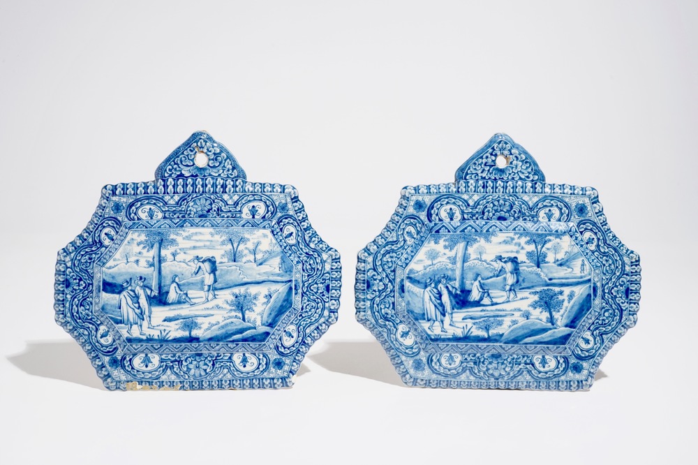 A pair of fine Dutch Delft blue and white plaques with travellers, 18th C.