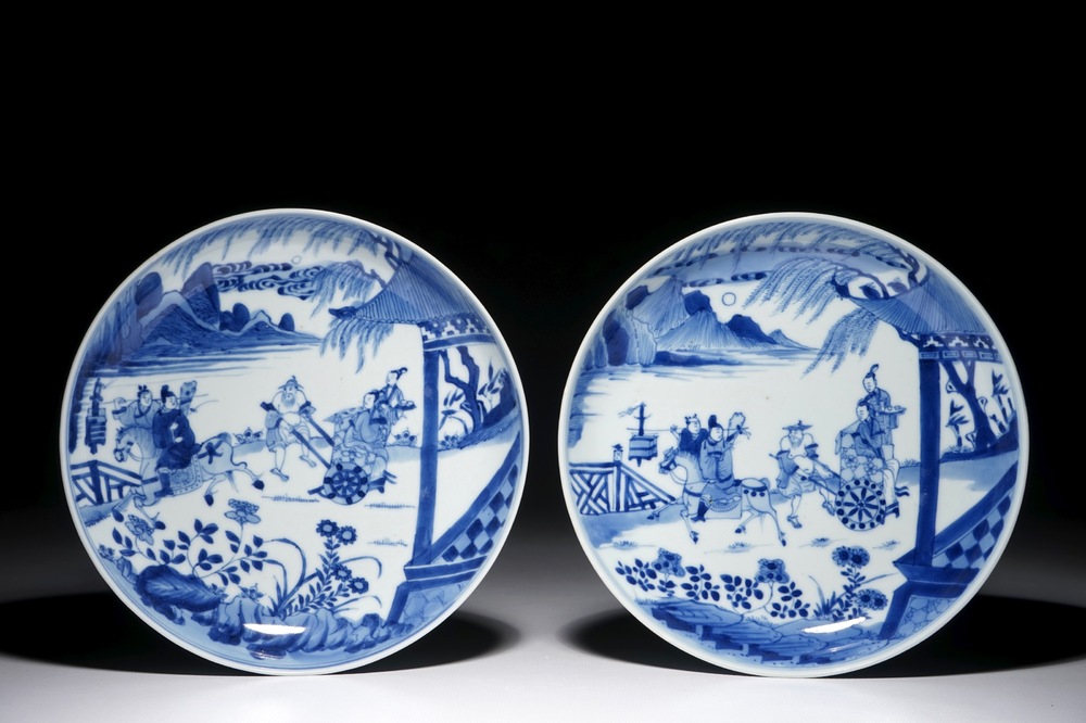 A pair of Chinese blue and white plates with figures in a garden, Kangxi