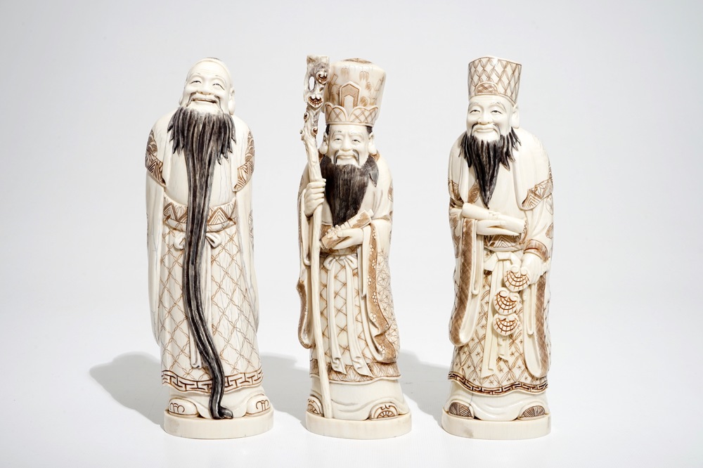 Three signed Japanese ivory okimono of bearded sages, Meiji, early 20th C.