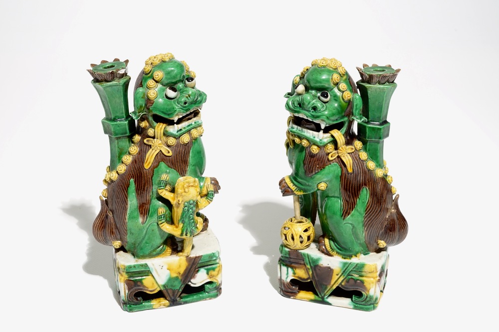 A pair of Chinese verte biscuit joss stick holders shaped as Buddhist lions, Kangxi