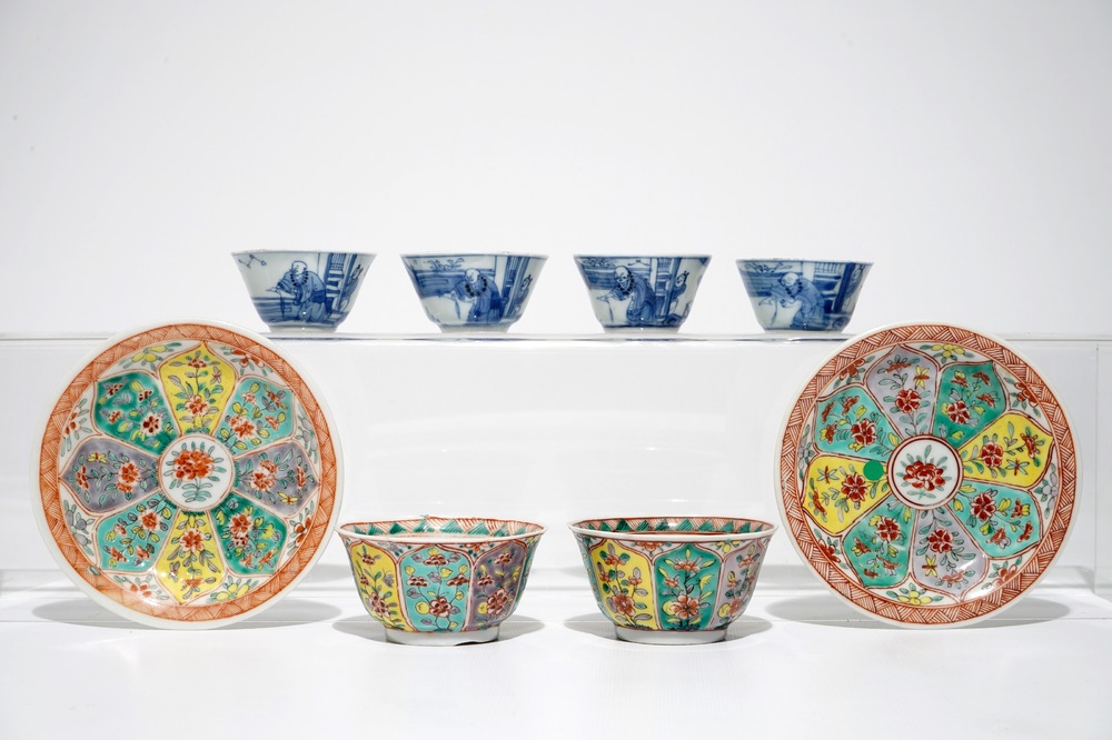 A pair of Chinese famille verte cups and saucers and four blue and white cups, Kangxi