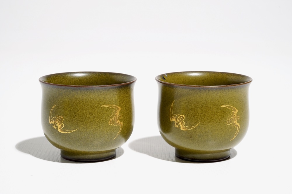 A pair of Chinese teadust-glazed and gilt wine cups with bats, Qianlong mark, 20th C.