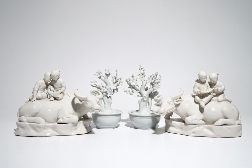 A pair of Chinese Dehua blanc de Chine prunus trees, Kangxi, and a pair of water buffalos with children, 20th C.