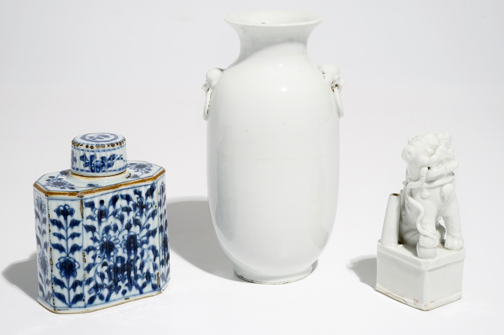 A Chinese Dehua blanc de Chine temple lion, a vase and a blue and white tea caddy, Kangxi and later