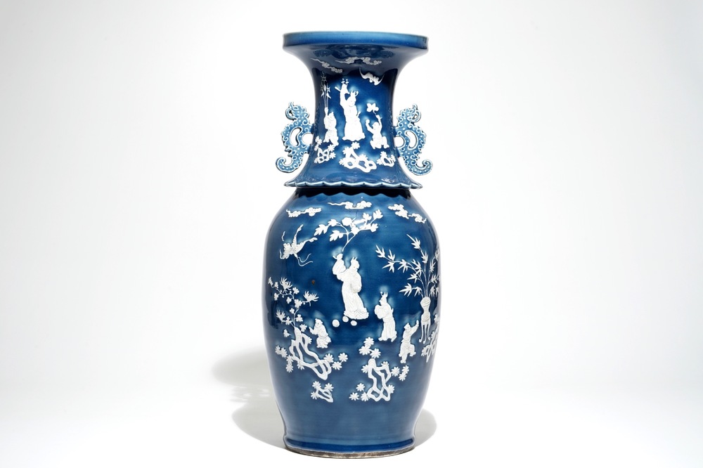 A tall Chinese blue-ground vase with applied white design, 19th C.