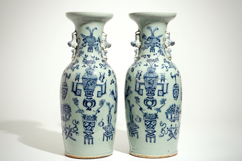 A pair of tall Chinese blue and white on celadon-ground vases, 19th C.