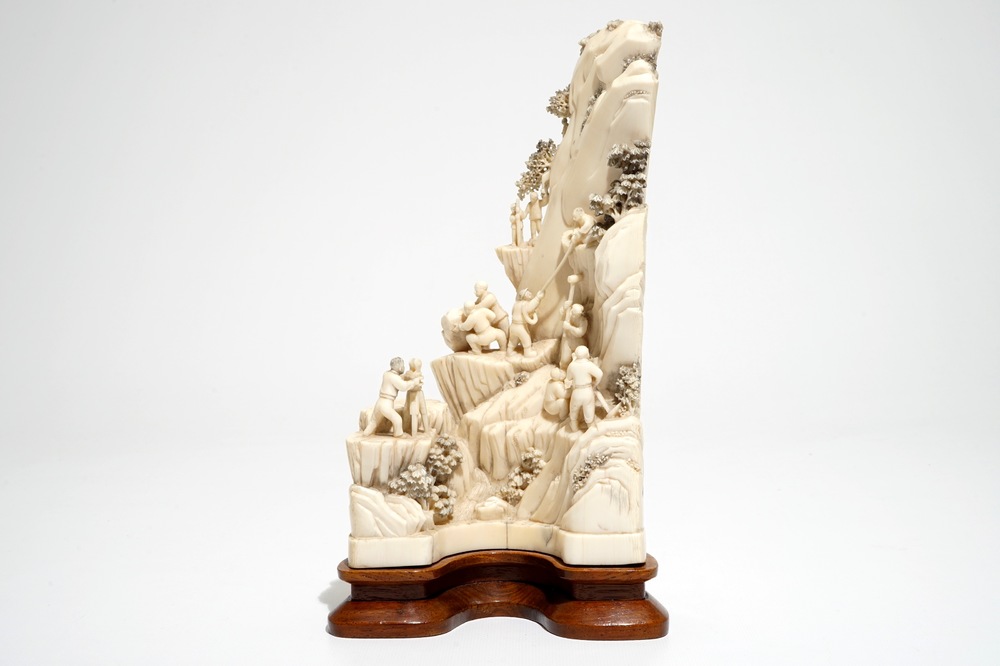 A Chinese ivory group of miners on a rock, 2nd quarter 20th C.