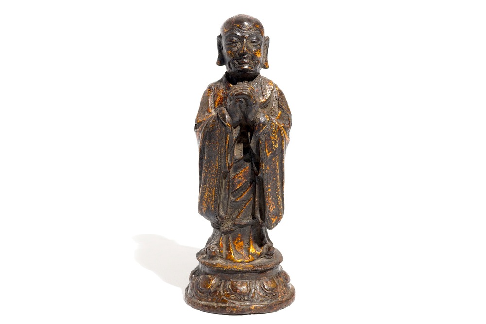 A Chinese gilt-laquered bronze figure of a monk, Ming