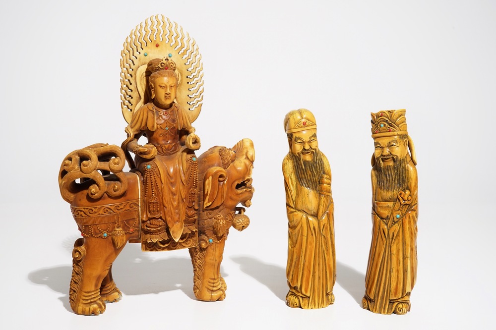 A Chinese ivory model of Guanyin on a Buddhist lion and two sages, 19th C.