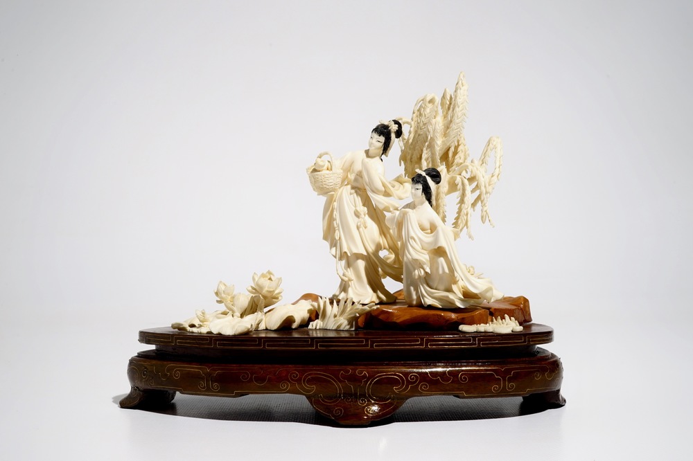 A Chinese carved ivory group of two ladies on wooden base, 2nd quarter 20th C.