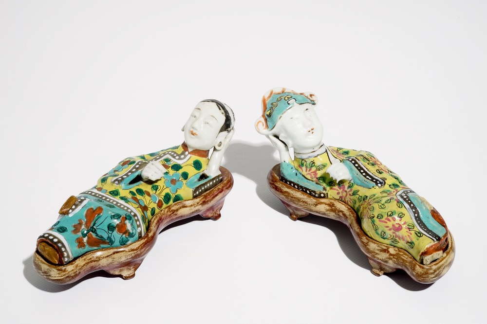 A pair of Chinese famille rose wall pocket vases shaped as resting figures, early 19th C.