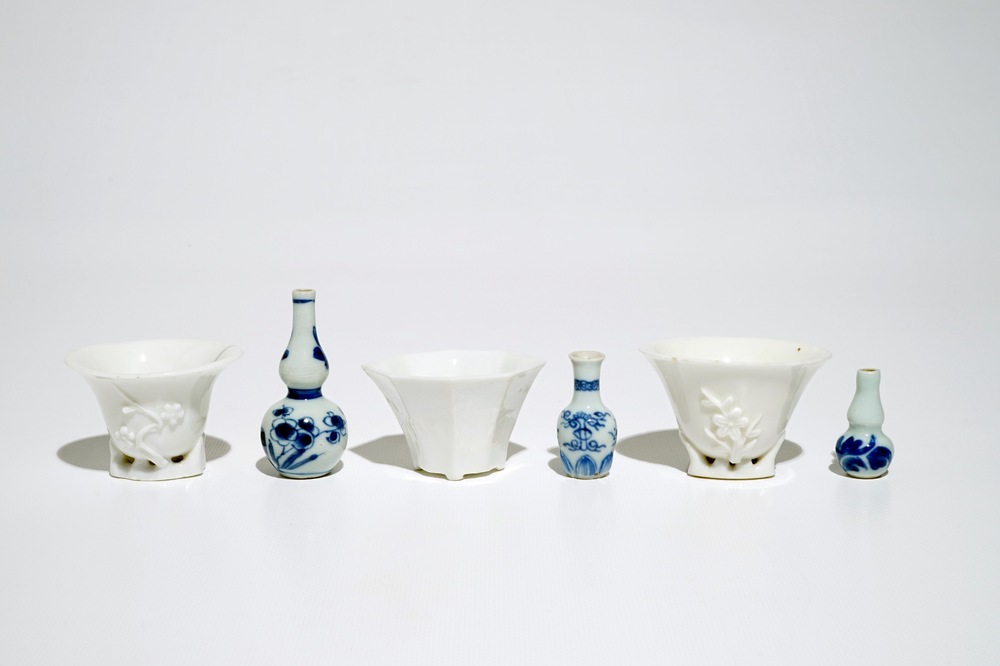 Three Chinese blanc de Chine libation cups and three blue and white miniature vases, Kangxi