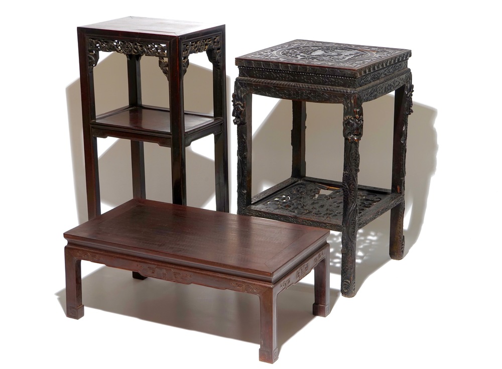 Two Chinese carved wood stands and a low table, 19th C.