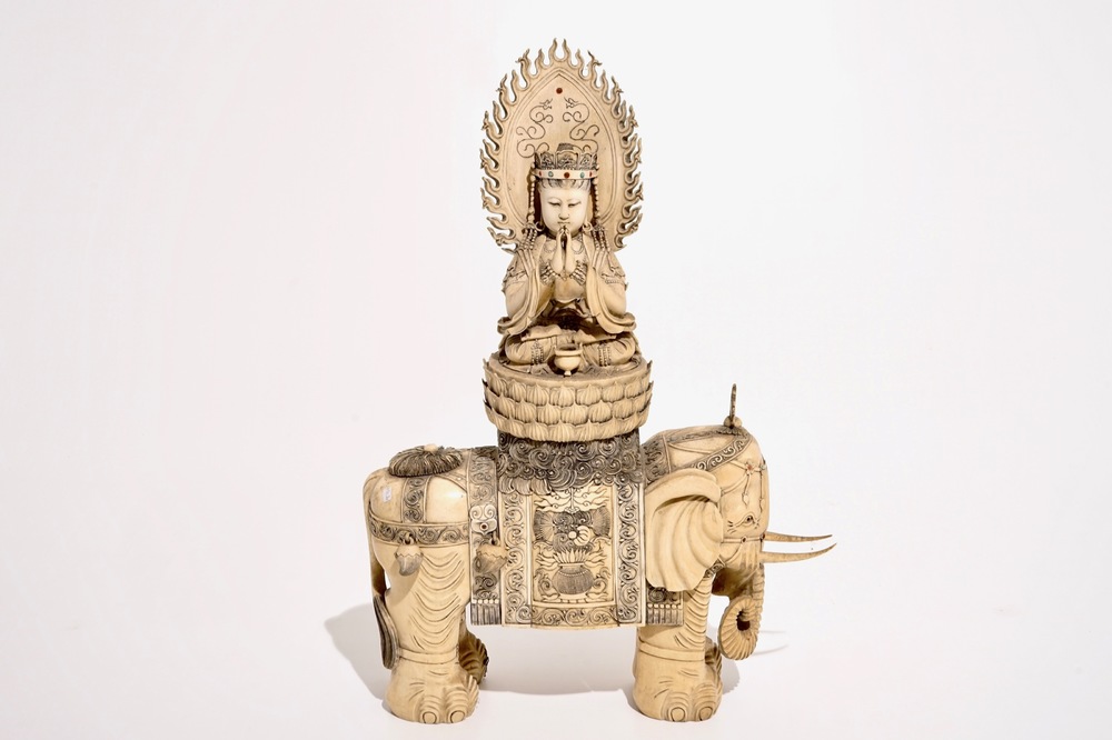A large Chinese ivory group of Guanyin seated on an elephant, late 19th C.