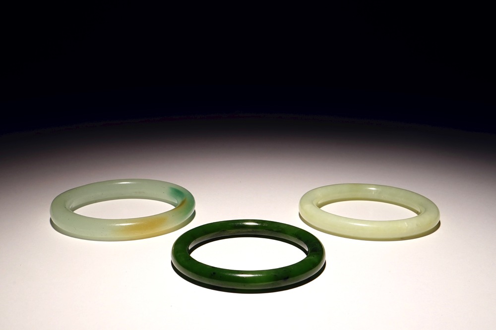 Three Chinese celadon and spinach green jade bangles, 19/20th C.