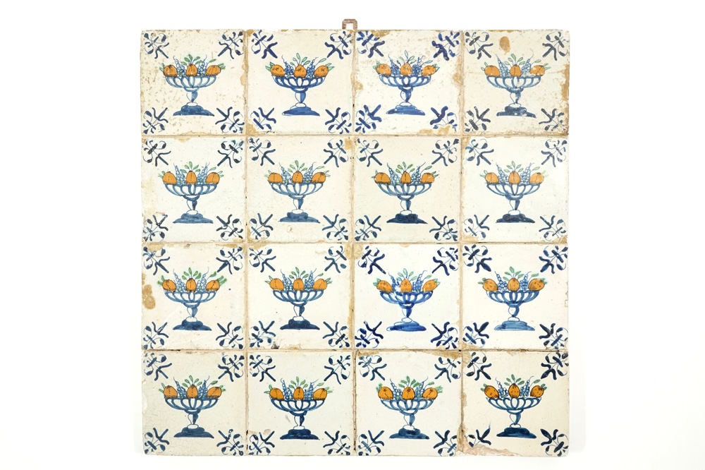 A field of 16 polychrome Dutch Delft tiles with tazza containing fruit, 17th C.