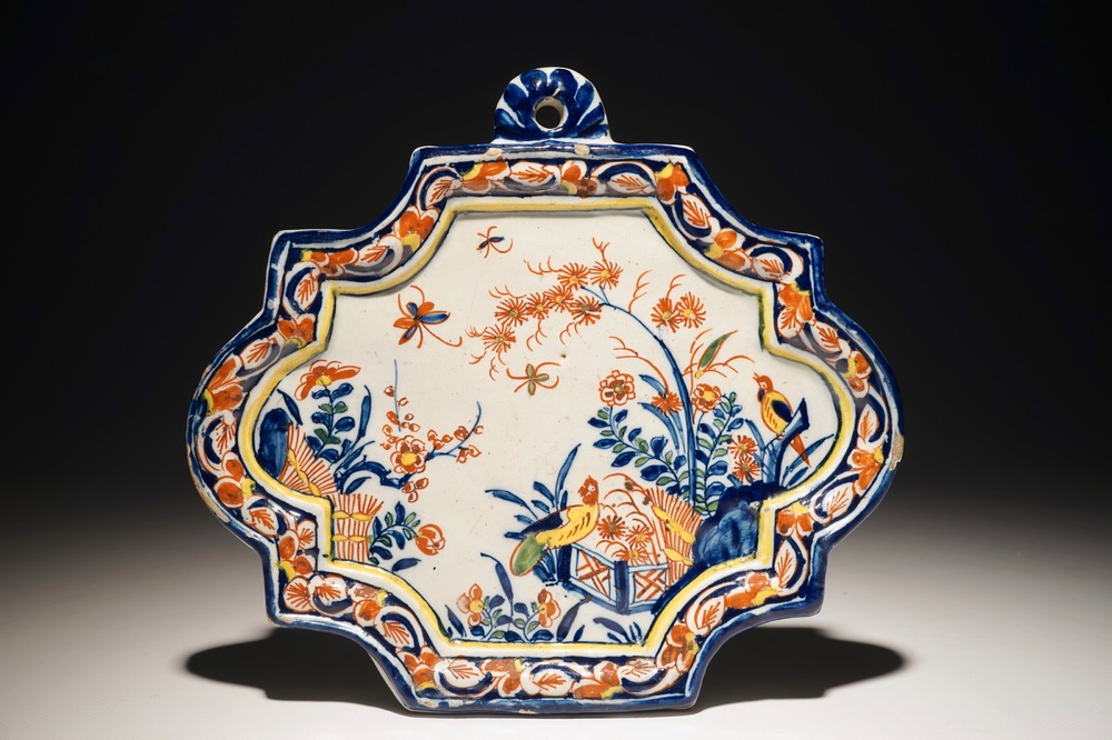 A Dutch Delft polychrome plaque with birds and insects among flowers, 18th C.