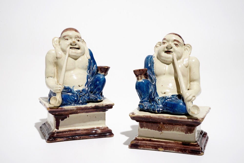 A pair of German faience models of Buddhas in Delft style, 1st half 18th C.