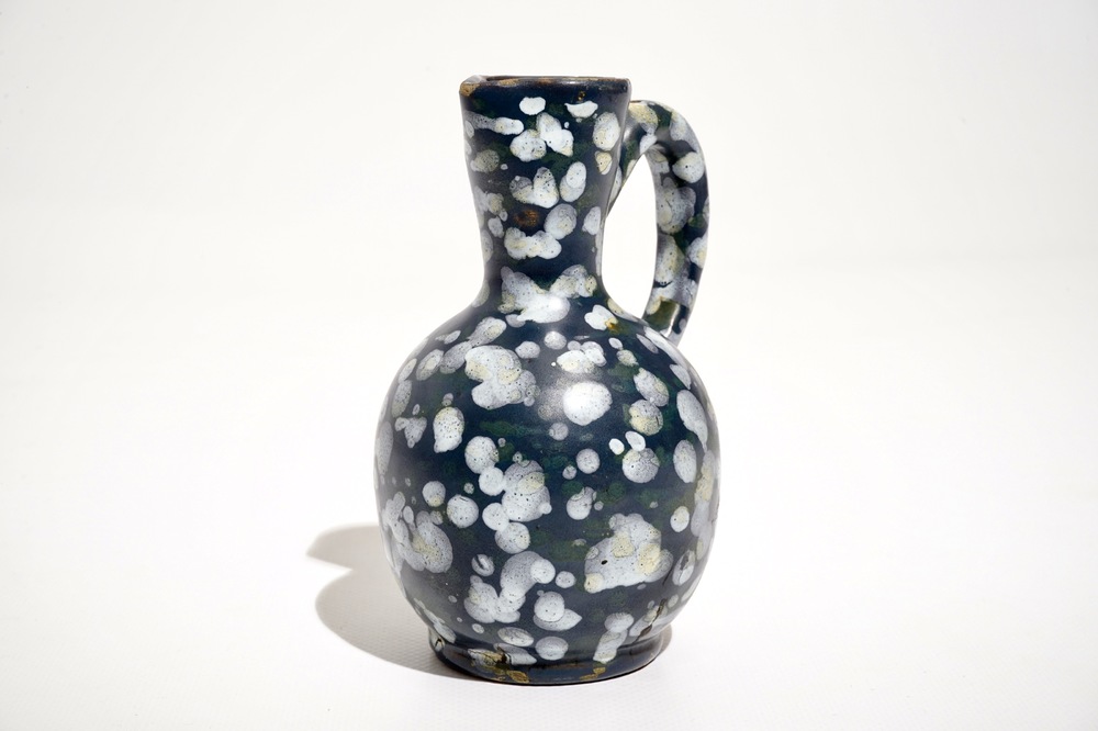 A French faience jug with blue ground &quot;A la bougie&quot; design, Nevers, 17th C.
