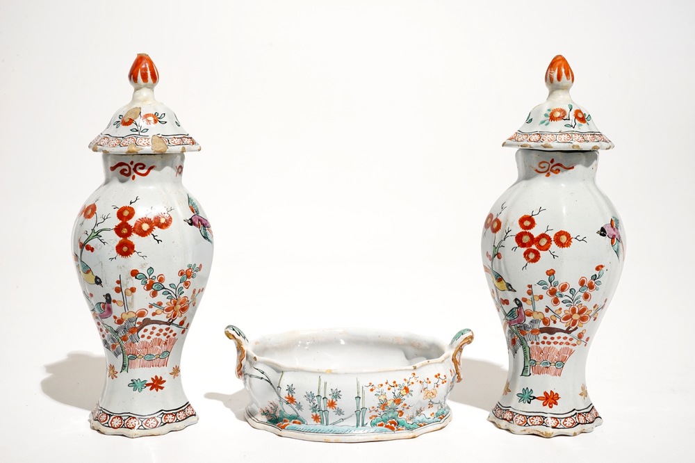 A pair of polychrome Dutch Delft petit feu Kakiemon style vases and a butter tub, 18th C.